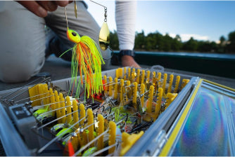 Man grabbing bait from tackle box